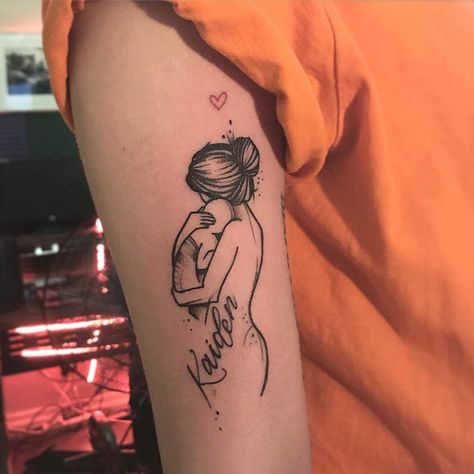 This sentimental parent tattoo shows a detailed line drawing of a mother and her baby. Click through for more tattoo inspiration at CafeMom. #tattoos #tattoodesign #tattooideas Miracle Baby Tattoo, Mutterschaft Tattoos, Tattoo Line Art, Tattoo For Baby Girl, Luck Tattoo, Twin Tattoos, Baby Tattoo Designs, 16 Tattoo, Parent Tattoos