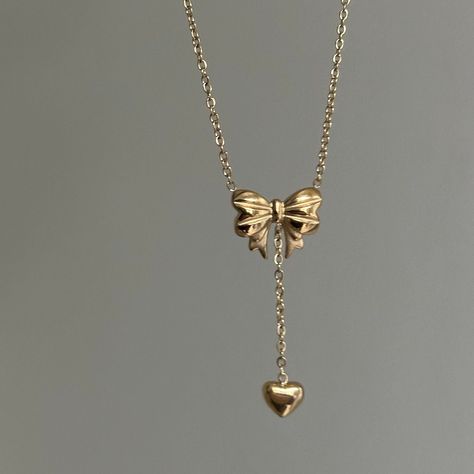 Bow Drop Heart Necklace  ✨ Fully stainless steel & tarnish proof! (18k gold plated/stainless steel) 15.5" with a 2" extender  oval link chain style featuring a unique mini puffed bow pendant & mini heart pendant 🤍 choose between silver or gold at checkout 😊 Handmade with love! Cute Heart Necklace, Gold Bow Jewelry, Gold Coquette Jewelry, Jewelry Accessories Gold, Pretty Jewellery Gold, Gold Necklace With Heart Pendant, Jelewry Gold, Dream Jewelry Necklaces, Gold Bow Necklace