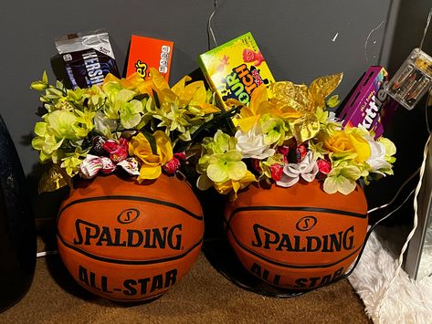 What you need: basketball, foam block, fake flowers, suckers, wooden dowels, candy. Basketball Flower Arrangements, Basketball Flower Bouquet, Basketball Senior Baskets, Basketball Diy, Basketball Senior Night Gifts, Basketball Centerpieces, Night Basketball, Basketball Cookies, Basketball Senior Night