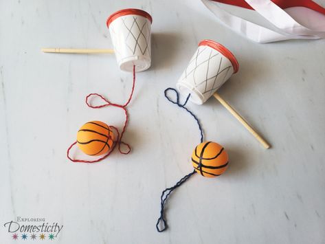 Basketball Cup and Ball Craft ⋆ Exploring Domesticity Wimbledon Crafts For Kids, Sport Craft Ideas, Cup And Ball Craft, Sports Diy Crafts, Sports Themed Crafts For Toddlers, Basketball Stem Activities, Cup And Ball Game Diy, Sports Day Craft, March Madness Activities For Kids