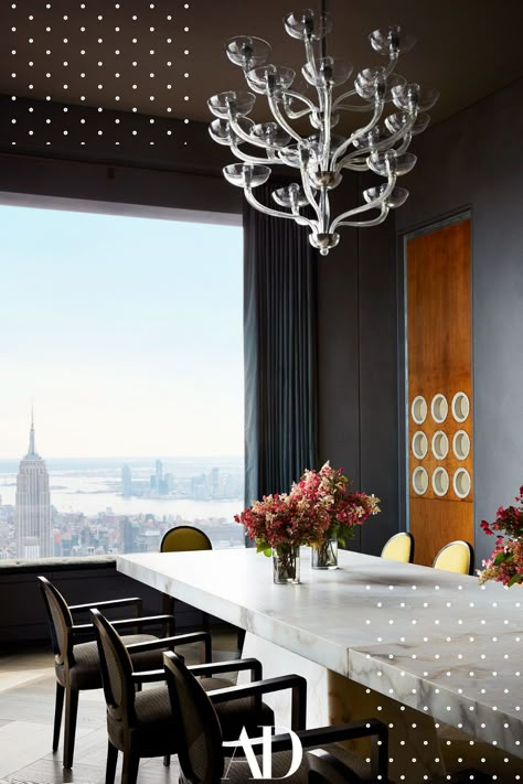 High above the gritty streets of Manhattan this luxurious apartment is a family home that rivals the toniest abodes of a bygone era complete with 360 views of Manhattan overlooking the dining room. #diningroom #chandelier #diningtable #windows #view #flowers #marble #chairs #table Manhattan Interior Design, Solid Oak Doors, Manhattan Apartment, Lighting Trends, Colour Inspiration, Structure Design, Step Inside, Architectural Digest, Wood Doors