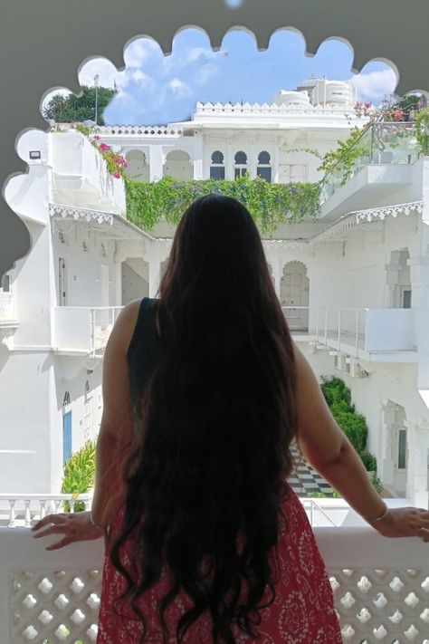 Girl in red, long skirt with long hair looking over the Jagat Niwas Palace in Udaipur Aesthetic Girl Indian, Udaipur Aesthetic, Udaipur Photography, Indian Outfit Ideas, Long Hair Aesthetic, Udaipur Palace, Hair Pic, Castle Architecture, Vintage Castle