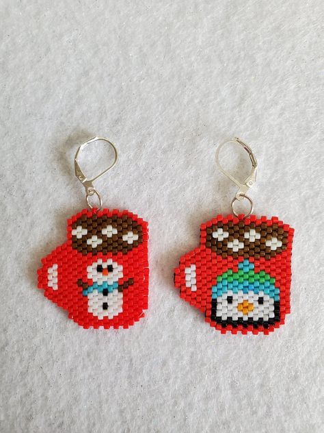 Hot Chocolate Mug Earrings  just in time for the Holidays!  These cute earrings  are hand made and will make great gifts or stocking stuffers. They are woven with the brick stich method using  Miyuki Japanese glass seed beads  (world class glass seed beads known for their brilliance, quality and perfect uniform shape).  One mug has a penguin and the other has a snowman. They are just slightly under 2 inches long and are approximately 1 inch wide. They come in a gift bag and will make a wonderful Seed Bead Christmas Earrings Free Pattern, Beaded Holiday Earrings, Perler Bead Christmas Earrings, Brick Stitch Christmas Earrings, Seed Bead Christmas Earrings, Christmas Bead Earrings, Holiday Earrings Diy, Beaded Christmas Earrings, Christmas Beaded Earrings