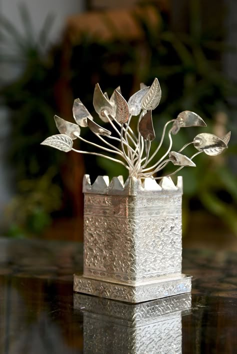 Buy this elegant german silver tulsi tree show piece and add to the class of your home. This show piece would go well with any number of different show pieces which makes it quite versatile to use. #germansilver #germansilverhandicraft #homedecor #handicarftitem #weddingfavor #returngift #nature #weddingreturngifts #jaipurhandicrafts #rajasthanhandicrafts #roomdecor Tulsi Tree, Tulasi Plant, Tulsi Pot, Tulsi Plant, Wedding Gift Pack, Peacock Wall Art, Show Piece, Personalized Wedding Decor, Silver Pooja Items