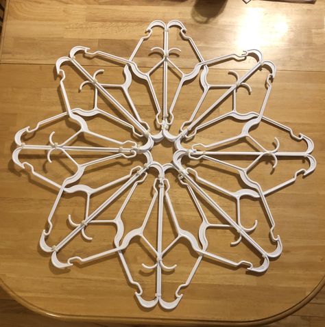 Snowflake made from plastic clothes hangers Hanger Snowflakes, Hanger Snowflake, Diy Hanger, Cheap Craft Supplies, How To Make Snowflakes, Plastic Clothes Hangers, Holiday Diy Projects, Hanger Crafts, Inexpensive Christmas