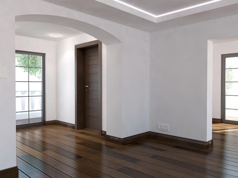 Baseboards Match Wall Color, Tile Baseboard Living Room, Brown Molding Wood Trim, Dark Brown Baseboards, Dark Baseboards Light Walls, Light Floors With Dark Trim, Walnut Baseboards And Trim, Dark Molding Light Walls, Wood Floor And Trim Combinations