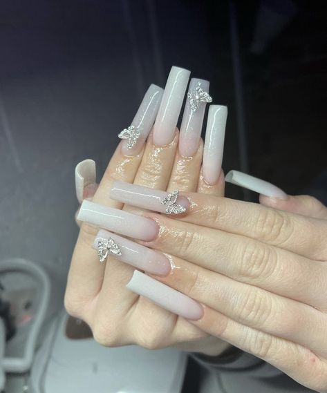 Milky Nails With Butterflies, Long White Nails With Charms, White Nails With Butterfly Charm, Milky White Nails Charms, Milky White Nails With Butterflies, Nails With Dangly Charm, White Nails Charms, White Charm Nails, Milk White Acrylic Nails With Design