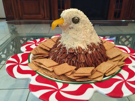 Patriotic Bald Eagle Cheeseball. My own creation. Use your favorite cheeseball recipe, mold into Bald Eagle shape, bottom of eagle covered with pecan halves, head covered with mozzarella cheese to look like feathers. I made the beak from a yellow bell pepper and the eyes with jalopena peppers but olives would do as well! Happy Independence Day! Eagle Food Ideas, Cheeseball Shapes Ideas, American Eagle Cheese Ball, Patriotic Cheese Ball, Bald Eagle Cheese Ball, 4th Of July Cheese Ball, Cheese Ball Shapes, Eagle Cheese Ball, Patriotic Food Appetizers