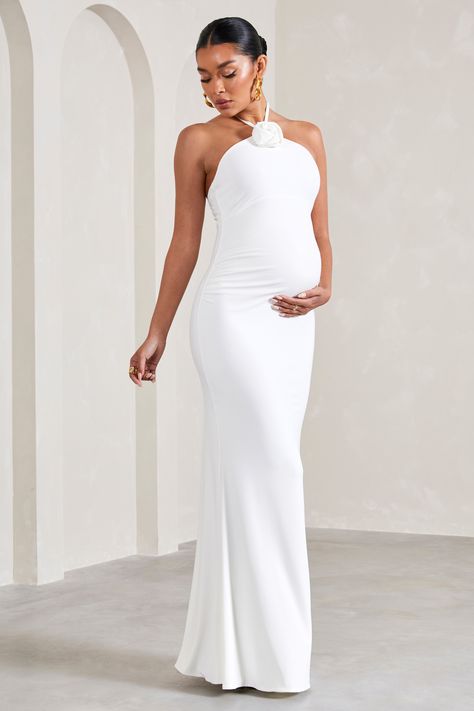 Exude a romantic state of mind in our white maternity maxi Loving. Defined by a statement floral corsage, this halter-neck arrives in a smooth stretch jersey renowned for its sculpting capabilities. For the perfect baby shower ensemble, try styling Loving with a sleek bun and strappy stilettos. Pregnant Photoshoot, Floral Corsage, Couple Pregnancy Photoshoot, Pranali Rathod, Pregnant Wedding, Maternity Maxi Dress, Sleek Bun, Cute Maternity Outfits, Maternity Outfits