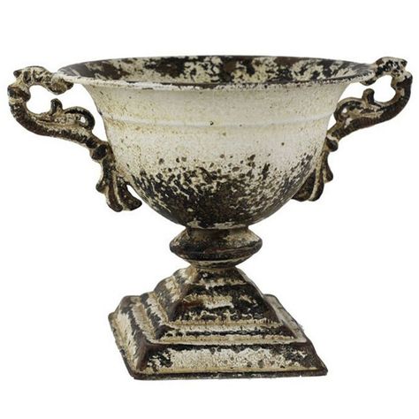 Elevate your home décor with this charming small urn, featuring a distressed white metal finish that exudes rustic elegance. Measuring 10.5 inches in diameter and 6 inches in height, this urn is a versatile decorative piece that complements a range of interior styles. Its sturdy metal construction ensures long-lasting beauty, while its vintage-inspired design adds a touch of classic charm. Ideal for placement on shelves, tables, or small spaces, this urn enhances any room with its timeless appea Chapel Decor, Outdoor Chapel, White Urn, Botanical Display, Vintage Flower Pots, Flower Farming, Aging Metal, Garden Urns, Urn Planters