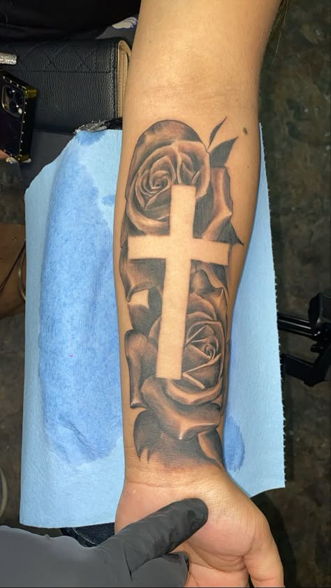 Tattoo Designs Men Cross, Cross Forearm Tattoo Men Half Sleeves, Cross With Flowers Tattoo Men, Cross With Names Tattoo Design, Cross Bicep Tattoo Men, Cross With Name Tattoo, Rose Tattoo With Cross, Tattoos For Guys Cross, Mens Rose Tattoo Forearm