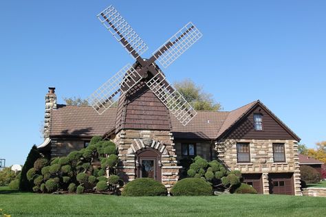 Windmill House - Wheaton, Illinois: - Built in 1942 from materials salvaged from a nearby farm, the Windmill House has an old-fashioned windmill above its front door, and is surrounded by otherwise normal suburban homes. Vertical Windmill, Wheaton Illinois, Windmill House, Windmill Water, Wind Mill, Old Windmills, Unusual Homes, Water Mill, Water Wheel