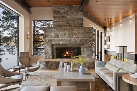 A serene lake house cuts into a rocky outcrop in Western Idaho Modern Cliff House, Granite Fireplace, Mountain Interiors, Modern Lake House, Cliff House, Brown Design, Curved Staircase, Cabinetry Design, Bunk House