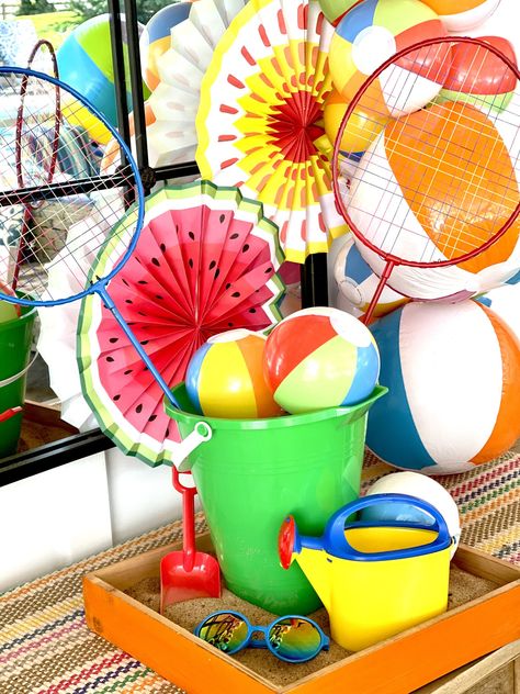 Dollar Store Sandbox Centerpieces Pool Party Table Centerpiece Ideas, Beach Bucket Centerpiece Ideas, Sand Bucket Centerpiece, Beach Ball Centerpiece, Bucket Centerpiece Ideas, Beach Party Centerpieces, Pool Party Centerpieces, Summer Table Centerpieces, Bucket Centerpiece