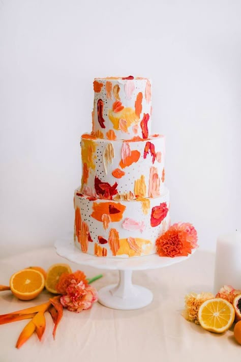 We’re spilling the juice on this painterly mid-century wedding inspiration with a citrus palette and contemporary-meets-exotic style. No pun intended! Pattern plays king in the geometric paper goods, embroidered wedding dress and brushstroke cake, as color makes a splash across the fruit-scattered table and tropical floral arrangements. Have we mentioned the stylish groom fashion yet? There is nothing you will not adore about this modern LA wedding venue and all the colorful designs that b Brushstroke Cake, Colorful Wedding Cakes, Tropical Floral Arrangements, Citrus Wedding, Torte Cupcake, Cake Trends, Orange And Pink, Savoury Cake, Wedding Cake Designs