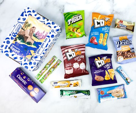 Universal Yums is an international snack subscription. Read the EGYPT box review + use coupon!   Universal Yums Subscription Box Review + Coupon - EGYPT →  https://hellosubscription.com/2020/08/universal-yums-subscription-box-review-coupon-egypt/ #UniversalYums  #subscriptionbox Universal Yums, International Snacks, Popcorn Snacks, Coconut Bars, Pizza Flavors, Cinnamon Cookies, Ice Cold Drink, Sour Candy, Warm Milk