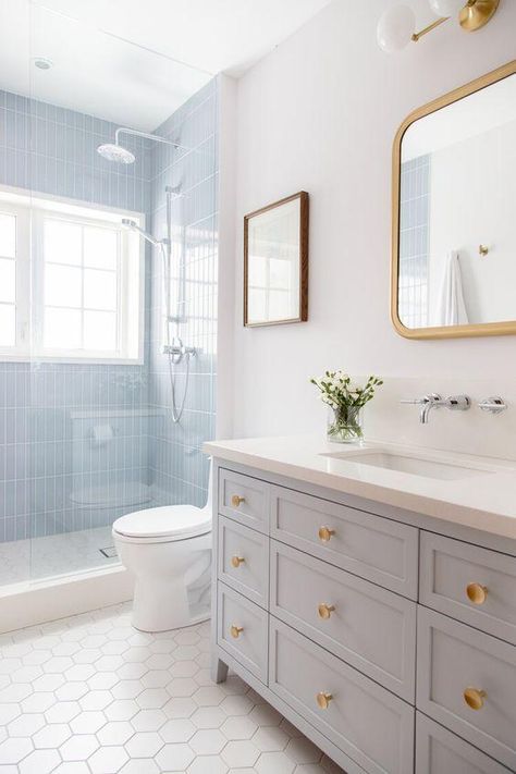 2025 Bathroom Trends and Design Ideas for Master Bathrooms and Small Baths – jane at home Small Bathroom With Blue Vanity, Bathroom Remodel 2024, Kids Bathroom Tile Ideas, Coastal Kids Bathroom, Light Blue Bathroom Tile, Bathroom Ideas Blue And White, Full Bath Ideas, Kids And Guest Bathroom Ideas, Grand Millennial Bathroom