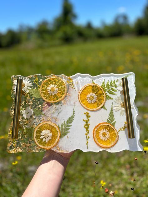 •Decorative serving tray set with 2 coasters. •Made with real dried oranges and pressed flowers. •The tray is 7x11 inches and the coasters are approximately 5 in. #resin #resinart #coasters #homemade #handmade #homedecorideas #flowers #preserving #giftforher #homedecoration #orange #kitchendecor #servingboard #etsy #etsyshop #smallbusiness #etsyfinds #etsyseller Dry Fruit Tray, Serving Tray Set, Serving Tray Decor, Flora Design, Orange Slice, Dried Orange Slices, Dried Oranges, Fruit Slice, Fruit Tray