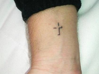 Although many people associate the stick and poke style of tattooing with prison tats, these single-needle tats are an awesome look for everyone. Stick and poke tattoos are actually more or less DIY tattoos, and pretty much anyone can do them. There are even S&P Tattoo Kits now available on the... Cross Shadow Tattoo, Christian Cross Tattoos, Poker Tattoo, Cross Tattoo On Wrist, Small Cross Tattoos, Male Tattoos, Simple Cross Tattoo, Tattoo Son, Tattoo Diy