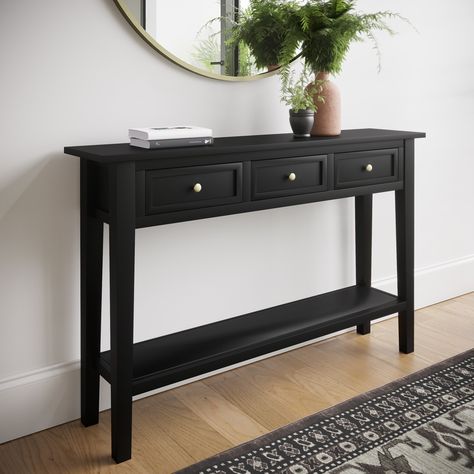 Features we love A classic farmhouse design for a warm homely feelThree drawers plus one lower shelf for supreme storageA smooth black painted finishCome with 2 handles options silver and goldAn elegant narrow design for slim spaces All about meMaximise your space and discover the perfect finishing touch for any hallway. This narrow console table has been beautifully finished in a sleek black with two options for your handles to complement most room themes and colour palettes. Pick and choose ho Black Console Table Entryway Gold Mirror, Small Hallway Table Ideas, Black Hall Table, Hall Console Table Ideas, Black Hallway Table, Narrow Entrance Hall Ideas, Black Console Table Entryway, Black Console Table Decor, Hallway Furniture Ideas