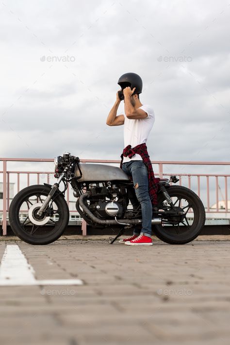 Brutal man near his cafe racer custom motorbike. by nikkolia. Handsome rider man with beard and mustache posing while take off black moto helmet near classic style biker cafe race... #Affiliate #nikkolia, #motorbike, #rider, #Handsome Moto Helmet, Man With Beard, Beard And Mustache, Biker Photoshoot, New Bicycle, Cafe Racing, Old Motorcycles, Biker Men, Cafe Racer Motorcycle