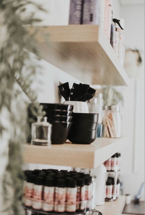 Colorful hair products organized on hanging shelves with plants