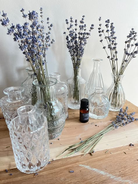 Lavender is well known to promote a sense of calm. We have created this all natural dried lavender aromatherapy diffuser to not only impart a beautiful smile into your home but to give a beautiful vintage inspired look.  A sweet posy of homegrown lavender a full size bottle of essential oil and vintage inspired bud vase is what you will get in this sweet little set.  We recommend starting with just a couple of drops of essential oil in the bottom of the vase. A little goes a long way. If you will be keeping this close to your bedside definitely start small however if you are trying to fill a room you may want to add a little more after you see how a couple drops does.  As with any essential oil please consult your doctor before exposing yourself to them. It's a good rule of thumb if you ar Lavender Plant Centerpieces, Lavender Vase Arrangement, Dried Lavender Bouquet In Vase, Dried Lavender Table Decor, Dried Lavender Centerpiece Wedding, Lavender Flower Decor, Dried Lavender Uses Decor, Dried Lavender In Vase, Dried Lavender Arrangements