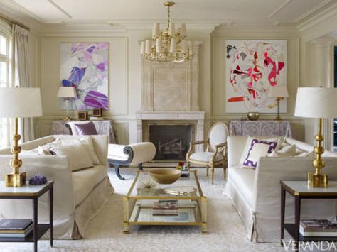 A monochromatic palette showcases boldly colorful art and accents. John Saladino sofas upholstered in Nancy Corzine silk canvas. Side tables, Suzanne Kasler for Hickory Chair. Coffee table, Jan Showers. Antique recamier from Herringbone Home. Chandelier, Nancy Corzine. Rug, Beauvais. Artwork, Aaron Wexler. Luxury Living Room Inspiration, Suzanne Kasler, Color Decor, Rustic Glam, Design Salon, Chic Living Room, The Fireplace, White Rooms, Luxury House Designs