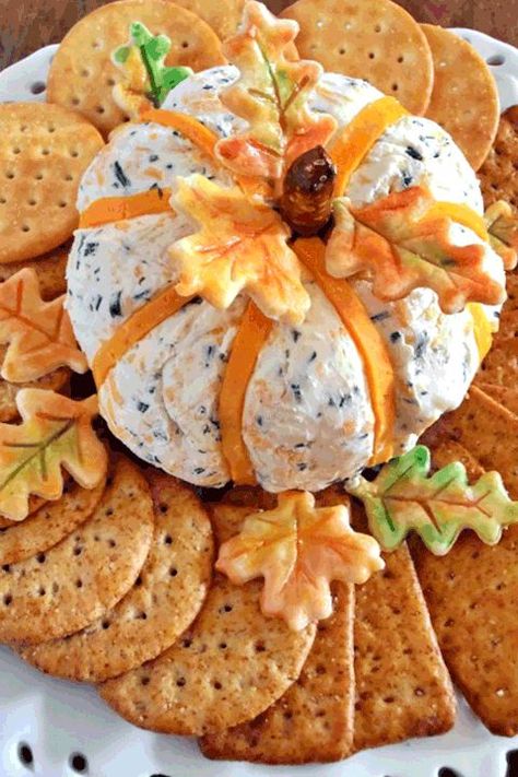 Once the cheese mixture is ready for eating, insert cheddar slices to make the pumpkin ridges. Serve with crackers or pita. Pumpkin Cheese Ball Recipe, Dinner 2023, Halloween Appetizer, Halloween Appetizers Easy, Halloween Party Appetizers, Appetizers For Kids, Easy Halloween Party, Party Appetizers Easy, Halloween Appetizers