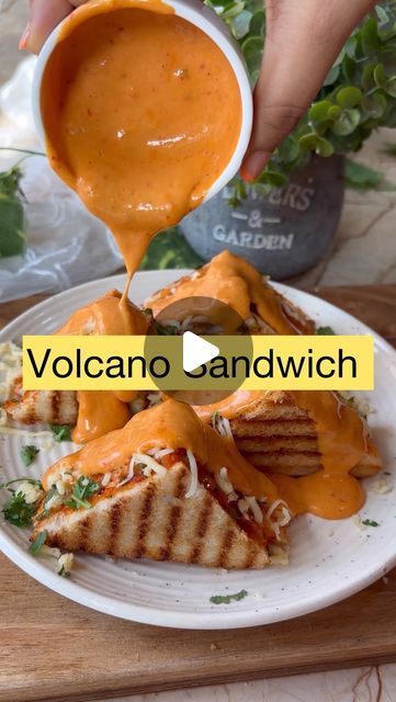 Neeti Jain on Instagram: "Schezwan cheese’ volcano sandwich 🥪🤤  Preparation time:40min Serve: 3 sandwiches   Ingredients used for cheesy schezwan sauce: •1tbsp butter •1tbsp refined flour  •1/2cup milk •1to2tbsp mayo •1/4th cup /2cheese cube grated cheese •2to3 tbsp schezwan sauce   *You can add salt if required   Ingredients used for filling: •1cup finely chopped cabbage  •1cup finely chopped capsicum  •1cup finely chopped onions •1tbsp green chilli •1/2tsp salt  •1/4th cup cheese/ 2cheese cube •Fresh coriander  •3to4tbsp schezwan sauce   Ingredients used: •Bread •Butter  •Schezwan sauce  •Cheese  #dosa #streetdosa #streetfood #pizzadosa #dosalovers #masaladosa #borivalifamousfood #foodporn #foodblogger #foodie #streetfoodindia #streetfoodlover #mumbaifood #mumbaisteetfood #borivali #bo Jain Bread Recipe, Volcano Sauce Recipe, Cabbage Sandwich, Cheese Dosa, Sandwich Recipes Indian, Mayo Sandwich, Schezwan Sauce, Jain Recipes, Mumbai Food