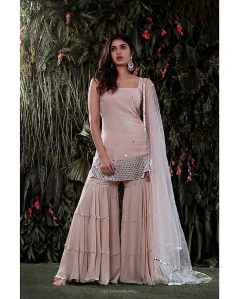 Sharara style is the most #trending outfit this season with#flaredpants and a dupatta. #sharara #pastelsuits #indianwedding #indianbride #wedding #bridaloutfit #latestsuits #trendingsuits #trendingsharara #latestsharara #weddingideas #weddinginspiration #shararadesigns #latestsharara #weddingideas #weddinginspiration #palazzopants #palazzosuits #palazzostylesuits #pakistanisharara #pakistanibride #pakistaniweddings #sareedesigns #lehengadesigns #indowesternoutfits #weddinglehenga #anarkalisuits Latest Indian Dresses Fashion Trends, Latest Sharara Designs Party Wear, Sharara Designs Simple, Sharara Look, Mehendi Outfit Ideas, Sharara Suit Designs, Sharara Style, Farewell Dresses, Reception Gowns