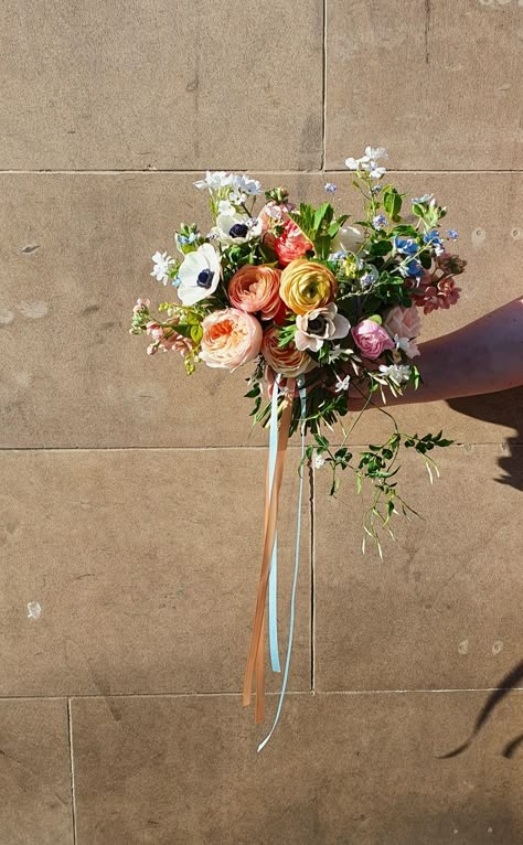 Spring bridal bouquet in pastel tones with trailing satin ribbons Featuring David Austin roses, ranunculus, anemone, oxypetalum, stocks and locally grown goodies Ranunculus Wedding Decoration, Trailing Bridal Bouquet, Ranunculus Bridal Bouquet, Whimsical Wedding Bouquet, Ranunculus Wedding Bouquet, Trailing Bouquet, Spring Bridal Bouquet, Ranunculus Boutonniere, Ranunculus Wedding