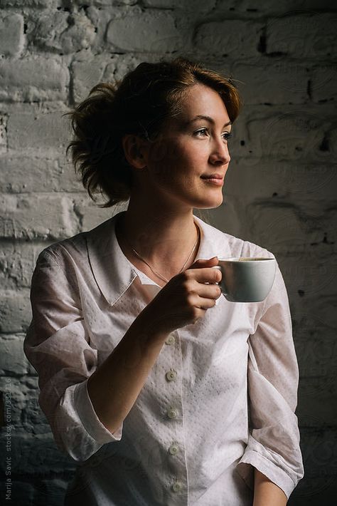 Woman Holding a Cup of Coffee  by Marija Savic for Stocksy United Holding Tea Cup Pose, Holding Cup Of Tea Reference, Hand Holding Tea Cup Reference, Coffee Holding Pose, Person Holding Teacup Reference, Woman Holding Coffee Cup, Holding A Coffee Cup Pose, Sipping Tea Pose Reference, Holding Mug Pose Reference