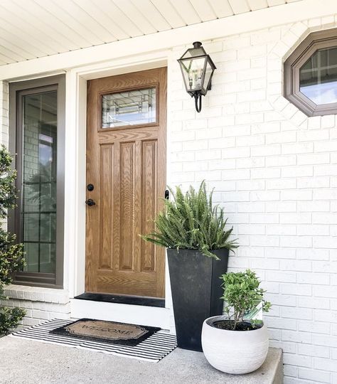 Whether you prefer colorful blooms or lush greenery, our collection of outdoor plant pots for the front door provides the perfect accent to elevate your home's curb appeal.

#FrontDoorDecor #OutdoorPlantPots #EntrywayElegance #FrontDoorFlowers #HomeEntrance #OutdoorDecor #CurbAppeal #GardenStyle Front Door Pots Plants Entrance Modern, Entry Outdoor Ideas, How To Layer Outdoor Rugs, Front Porch Inspiration Modern, Outdoor Pots Front Door, Front Porch Decorating Modern, Snake Plant Front Door, Painted Brick Cottage Exterior, White Brick Front Porch