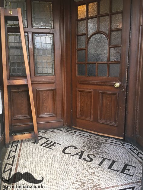 Victorian entrance to The Castle pub at Harrow, London, with mosaic tiles and woodgrained doors and panelling  #victorianmosaic #mosaicfloor #heritagepubs #victorianpubinteriors Pub Entrance, Pub Exterior, Victorian Entrance, Irish Pub Decor, Dispensary Design, Gentlemans Room, Pub Interior Design, Acacia Kersey, Unique Tiles