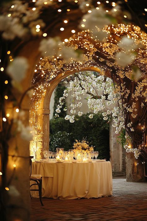 Round table under an arch of blooms and twinkling lights. Get enchanted by wedding decor ideas that remain elegant across the ages while impressing even the pickiest Aunt Mildred. Wedding Arch Ideas Lights, Timeless Wedding Decor, Wedding Arch Ideas, Floral Archway, Twinkle String Lights, Arch Ideas, Wedding Decor Ideas, Wooden Pergola, Wedding Set Up