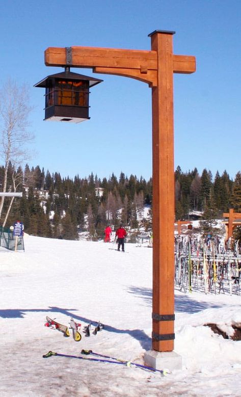 Custom wood built light post at a ski resort with a gas lantern hanging from it. Skis and snow surrounding it.  Caribou Creek Log Homes builds more than just houses. We build specialty item such as staircases, entry ways, sign posts, and custom furniture. #Cariboucreekloghomes #handcraftedlogstructures #handcraftedstaircase Rustic Light Post Outdoor, Driveway Posts, Garden Lamp Post, Lantern Hanging, Driveway Lighting, Outdoor Lamp Posts, Driveway Entrance, Light Post, Lantern Post