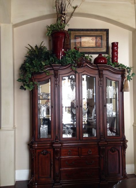 China cabinet decoration -- I would use different colors, but I like the varied heights.  Add lights to the greens? On Top Of Cabinet Decor, Top Of Cabinet Decor, China Cabinet Decor, Above Cabinet Decor, Tuscany Decor, Decorating Above Kitchen Cabinets, Top Of Cabinets, Cabinet Decoration, Cabinet Top