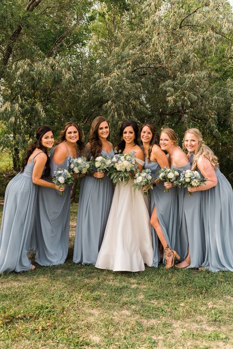 Dusty Blue Bridesmaid Dress Photos with the bride. Bridesmaid bouquets with dusty blue and white flowers. #dustybluewedding #dustybluebridesmaiddresses #FortCollinsWedding Bridesmaid Dress Blue Dusty, Dudty Blue Bridesmaids Dresses, Cloudy Blue Bridesmaid Dresses, Dusty Blue Dress Bridesmaid, Dusty Blue Chiffon Bridesmaid Dress, Duty Blue Bridesmaid Dresses, Dusty Blue Bridesmaid Dresses Fall, Stormy Blue Bridesmaid Dress, Powder Blue Wedding Theme Bridesmaid Dresses