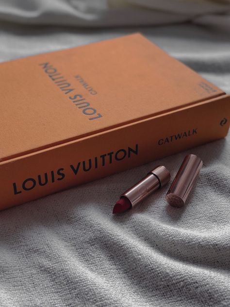 Blanket orange book Louis Vuitton Catwalk matte red lipstick from Anastasia Beverly Hills Louis Vuitton Catwalk, Louis Vuitton Catwalk Book, Louis Vuitton Book Aesthetic, Louis Vuitton Book, Ideal Aesthetic, Girly Makeup, Luxurious Room, Fashion School, Aesthetic Life