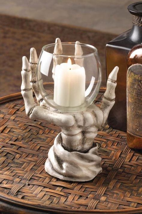 Skeleton Hand: Place a votive holder with a subtle skeleton hand sculpture around it on a bookshelf for some unassuming (but festive) decor. Click through for more Halloween decorating ideas! Skeleton Candle Holder, Skeleton Candle, Elegant Halloween Decor, Halloween Haunted House Decorations, Elegant Halloween, Spooky Halloween Decorations, Hand Sculpture, Crazy Stuff, Scary Halloween Decorations