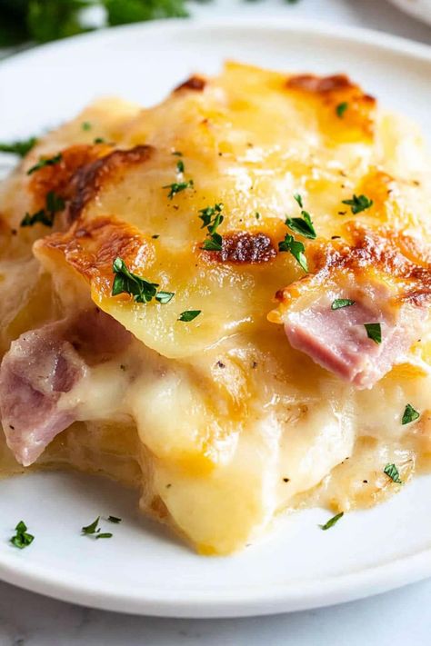 This cheesy scalloped potatoes and ham is absolutely to die for! Serve it as a creamy main course or decadent side dish to meats. Ham And Cheesy Scalloped Potatoes, Scalloped Potatoes And Ham Pioneer Woman, Freezer Scalloped Potatoes And Ham, Easy Ham And Scalloped Potato Casserole, Creamy Scalloped Potatoes And Ham, Joanna Gaines Side Dishes, Scalloped Potatoes With Cream Cheese, Scalp Potatoes And Ham Recipes, Cheese Sauce For Scalloped Potatoes