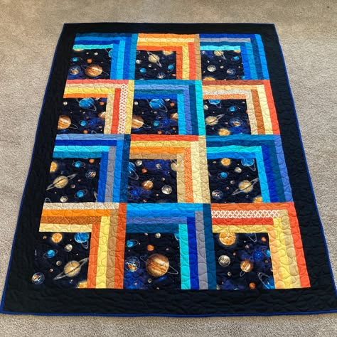 Space; the final frontier! Yes, I've been humming the theme to Star Trek every time I see this quilt. Blocks of planet print fabric bordered by random strips of blue, yellow, and orange that give it a feeling of motion/climbing. I recently displayed this striking little quilt at an art show where it got a high percentage of the evening's oohs and aahs! Medium sized throw great for your favorite astronomer OR sci-fi fan. Back is navy cotton, binding is hand sewn. Sturdy enough for years of use an Space Quilts Ideas, Space Quilt Pattern, Pixel Quilts, Boy Quilts Ideas, Quilts For Boys, Kids Quilts Ideas, Space Theme Crochet Blanket, Space Themed Quilt Patterns, Outer Space Quilt