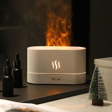 The Flame Aroma Diffuser equips built-in intelligent LED lights and mist to create a realistic flame effect, adding a soothing atmosphere to your home/office/gym. With a compact, convenient, portable design, the flame humidifier is made up of high-quality PP material, a simple button design, and warm ambient light to make the user feel safer and more at ease. Its quiet operation mode offers a peaceful environment to help relieve stress and improve sleep quality. Aromatherapy Humidifier, Trending Gadgets, Air Diffusers, Air Humidifier, Aromatherapy Oils, House Smells, Aroma Diffuser, Essential Oils Aromatherapy, Essential Oil Diffuser