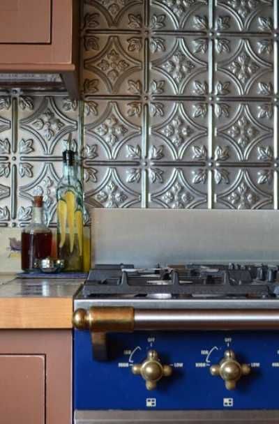 23 Tin Backsplash Design Ideas for Your Kitchen | Sebring Design Build Silver Tin Backsplash Kitchen, Tin Ceiling Tile Backsplash, Cheap Backsplash Kitchen, Aluminum Backsplash Kitchen, Copper Tin Ceiling Kitchen, Fasade Backsplash Kitchen, Metal Kitchen Backsplash Ideas, Metal Backsplash Behind Stove, Kitchen Ideas Backsplash