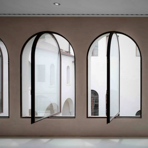 Black steel framed windows with arched heads Arched Steel Windows, Arch Window Interior, Black Arch Windows Exterior, Modern Arched Windows, Arched Window Design, Modern Arch Window, Arch Windows Exterior, Arched Windows Exterior, Arch Window Design