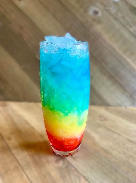 Rainbow Paradise Mocktail Recipe - FlyPeachPie Pride Month Mocktails, Rainbow Mocktail Recipe, Rainbow Mocktails Non Alcoholic, Layered Mocktail Recipe, Rainbow Drinks, Rainbow Stuff, Layered Drinks, Orange Julius, Blue Curacao