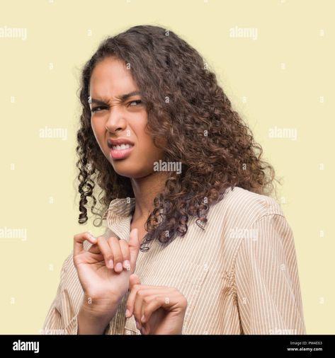 Download this stock image: Young hispanic business woman disgusted expression, displeased and fearful doing disgust face because aversion reaction. With hands raised. Annoying c - PW4E63 from Alamy's library of millions of high resolution stock photos, illustrations and vectors. Disgusted Face, Business Women, Stock Photography, Stock Images, Resolution, Stock Photos, Illustrations, T Shirts For Women, Photography