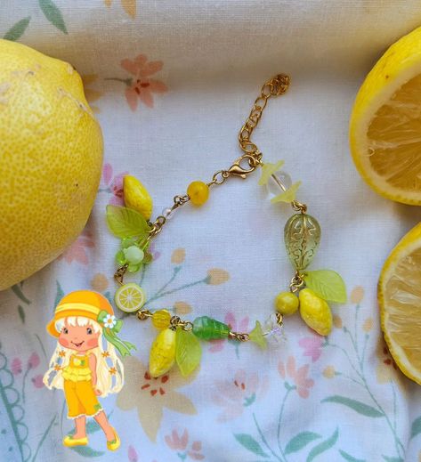 🍋 Lemon Meringue bracelet 🍋 . . ☆ lemon charms made with polymer clay ☆ features lampwork glass bead, other flower glass beads, and polymer clay lemon slice bead . . . #handmade #beadedaccessories #beadings #strawberryshortcake #accessories #polymerclay #lemonmeringue #lemons #yellow #y2k Polymer Clay Lemon, Yellow Y2k, Lemon Slice, Lemon Meringue, Beaded Accessories, Lampwork Glass Beads, Strawberry Shortcake, Meringue, Glass Bead