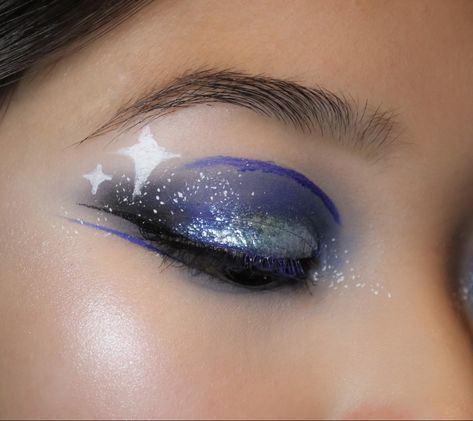 starry eyed makeup, midnights taylor swift inspired makeup, blue eyeshadow, creative eye makeup idea, glowy face makeup, blinding highlight, sparkly eye makeup, glittery makeup, juvia’s place duochrome liquid glitter eyeshadow, halsey about-face blue matte fluid eye paint, blue lip, lipstick, night makeup, makeup for eyes with epicanthic fold, asian eye makeup, fun face paint makeup, smoky blue makeup, brown eyes, highlighter makeup, full-face makeup, white dots, stars eye makeup, white eyeliner Midnights Inspired Makeup, Glowy Face Makeup, Midnights Taylor Swift Makeup, Eye Makeup White Eyeliner, Blue Makeup Brown Eyes, Stars Eye Makeup, Space Themed Makeup, Taylor Swift Inspired Makeup, Eye Makeup White